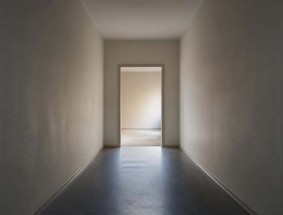Empty hallway leading through an open doorway